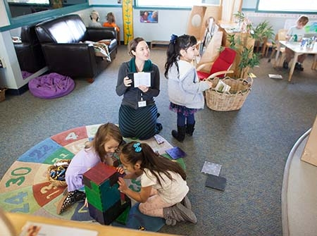 Teacher showing a book to children